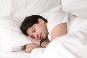 young-guy-sleeping-bed-wearing-smartwatch-sleep-tracker_1024x1024.jpg