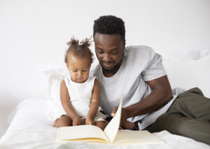35cf1ffa-father-reading-her-baby-girl.jpg