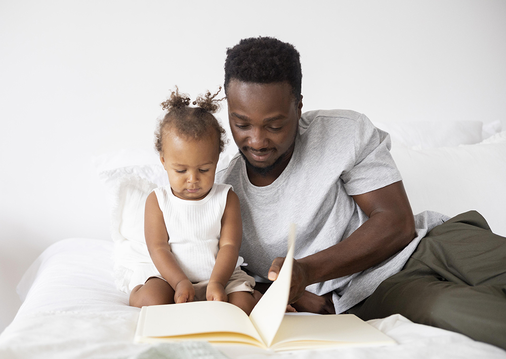 35cf1ffa-father-reading-her-baby-girl.jpg