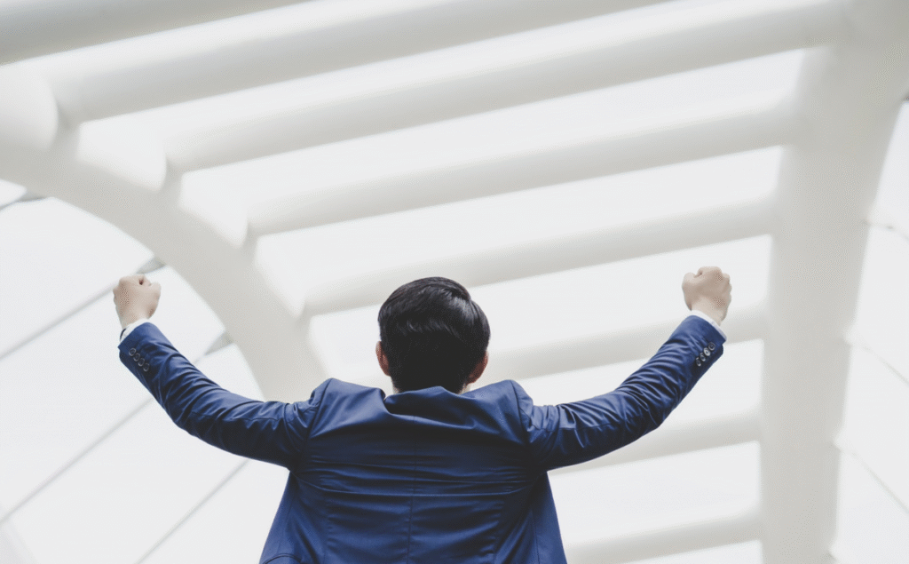 Successfully_of_young_businessman_keeping_arms_raised_and_expressing_positivity_1200x1200.png