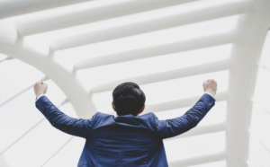 Successfully_of_young_businessman_keeping_arms_raised_and_expressing_positivity_1200x1200.png