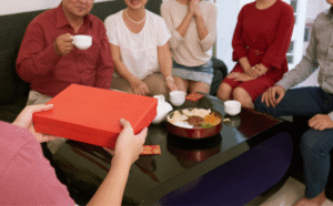 a_person_giving_present_to_family_1200x1200.png