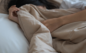 A_girl_covering_her_face_with_a_blanket_while_sleeping_b5c3dd43-7496-4959-b082-939292e8ead5_1200x120.png