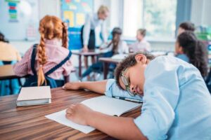 overworked-african-american-schoolboy-sleeping-in-2022-12-16-18-07-07-utc.jpg