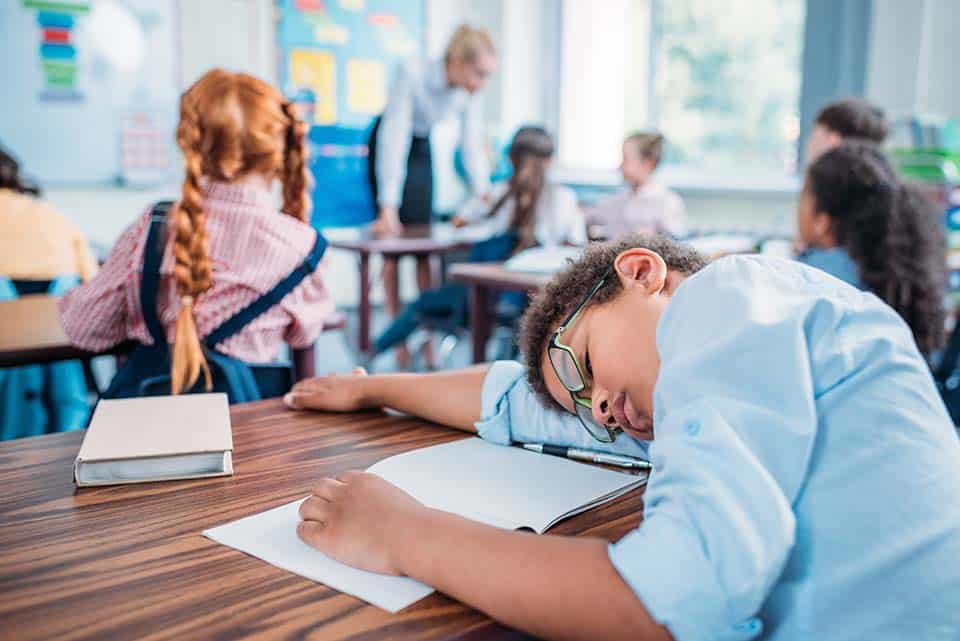 overworked-african-american-schoolboy-sleeping-in-2022-12-16-18-07-07-utc.jpg