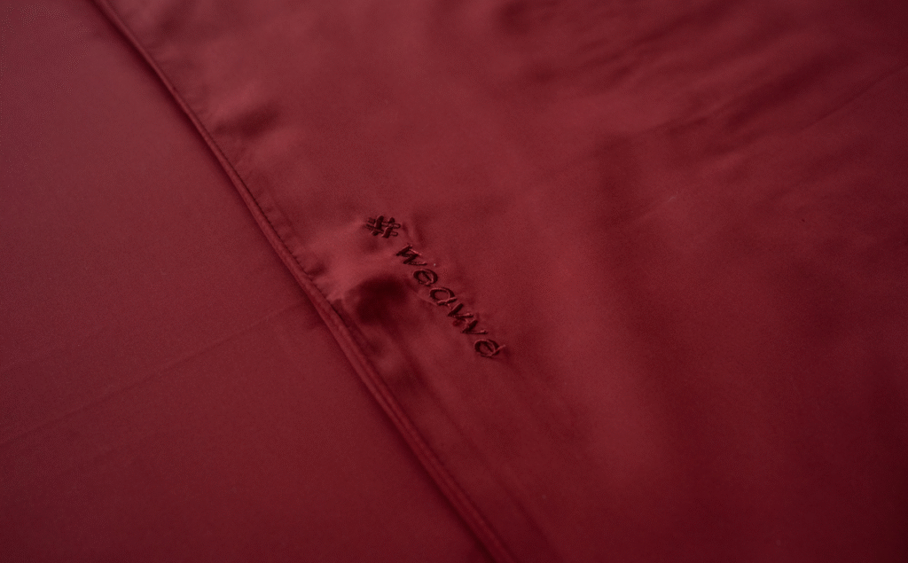 A_close-up_of_a_red_sheet_embroidered_with_the_word_Weavve_d768e304-65b9-41ad-84f5-f024bf3caaad_1200.png