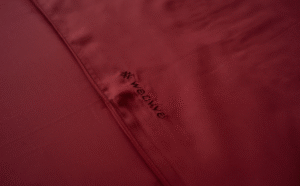 A_close-up_of_a_red_sheet_embroidered_with_the_word_Weavve_d768e304-65b9-41ad-84f5-f024bf3caaad_1200.png