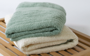 A_close_up_of_two_towels_on_a_wooden_shelf_16067ef0-e397-4195-85b9-db2ab1c1424e_1200x1200.png