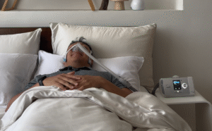 A_man_sleeping_with_a_CPAP_machine_1200x1200.png