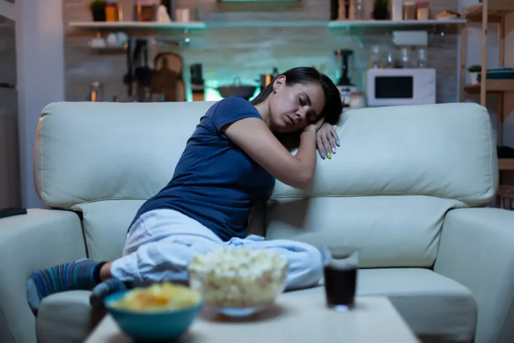 portrait_woman_sleeping_couch_living_front_television_tired_exhausted_lonely_sleepy_lady_pajamas_fal.webp