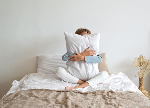 hugging-pillow-in-bed_7d22ed98-6d63-46d8-88e7-f6748a076ef7.jpg