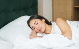 A_woman_peacefully_sleeping_on_white_bedding_resting_her_head_on_a_soft_pillow._1200x1200.png