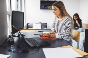 woman-student-sitting-by-her-desk-in-the-dorm-room-2022-12-16-17-18-32-utc.jpg